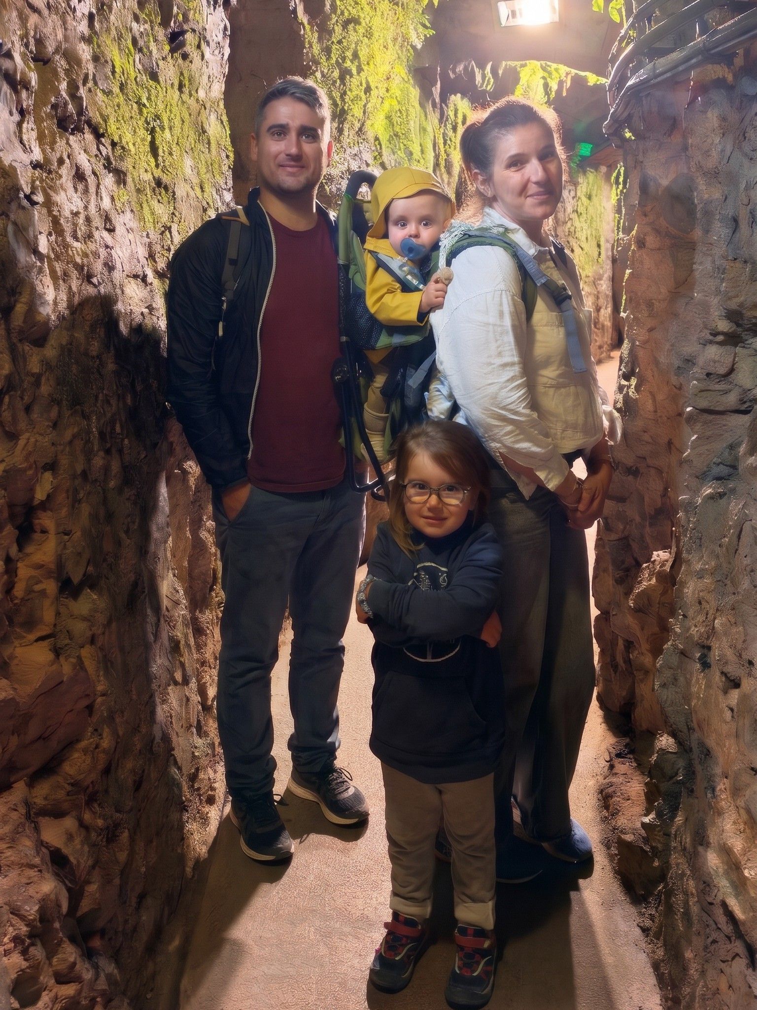 Guillaume with his wife Sabine, their daughter Louise and their son Charles in a baby carrier, in a stone tunnel